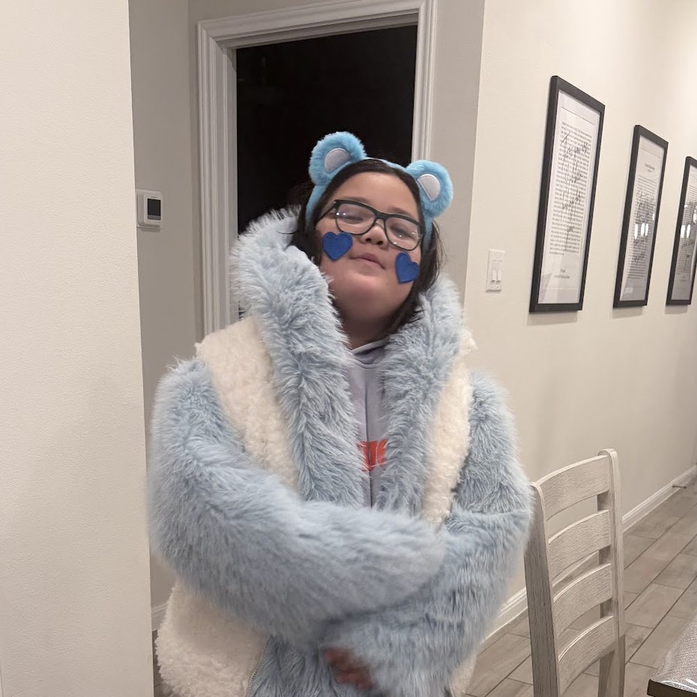 Lincoln wearing a fuzzy blue coat and bear ears