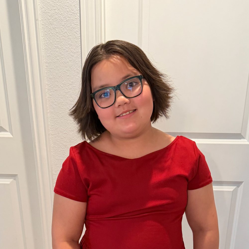 Lincoln in a red dress before a singing recital
